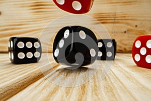 Red and black dice cubes on wooden background