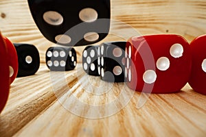 Red and black dice cubes on wooden background