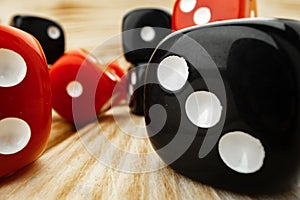 Red and black dice cubes on wooden background