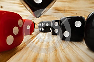 Red and black dice cubes on wooden background