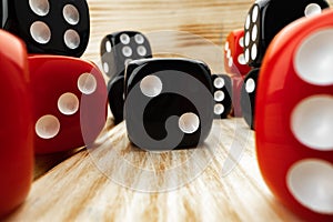 Red and black dice cubes on wooden background