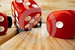 Red and black dice cubes on wooden background