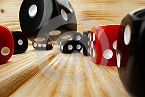 Red and black dice cubes on wooden background