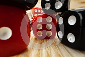 Red and black dice cubes on wooden background