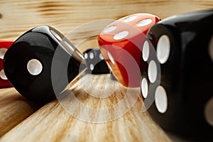 Red and black dice cubes on wooden background