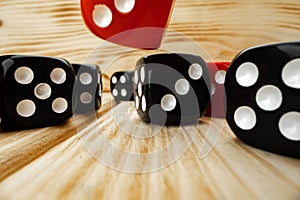 Red and black dice cubes on wooden background