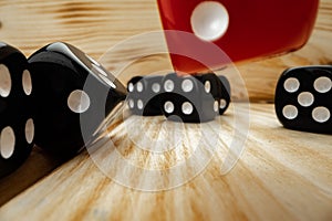 Red and black dice cubes on wooden background