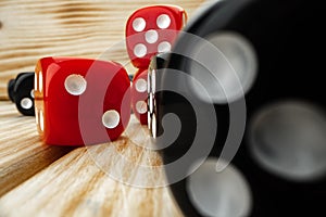 Red and black dice cubes on wooden background