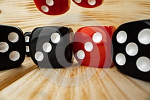 Red and black dice cubes on wooden background