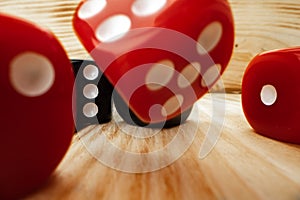 Red and black dice cubes on wooden background