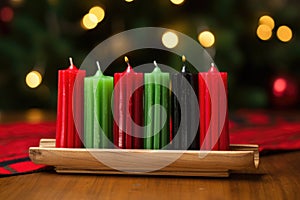 red, black, green candles in a wooden kwanzaa kinara