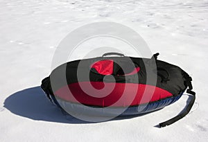 Red and black material snow inner tubing (toobing) on the white