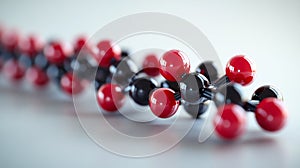 A red and black molecule is shown in a close up