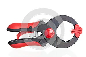Red and black plastic clamp isolated on white