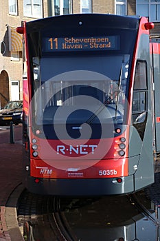 Red black R-NET tram streetcar on line 11 at the end of line loop at the beach of Scheveningen.