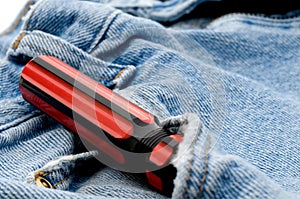 Red and black screwdriver in jeans pocket