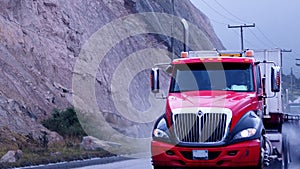 Red and black truck on the rain photo