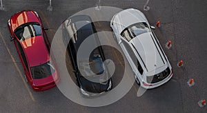 Red, black and white cars parked