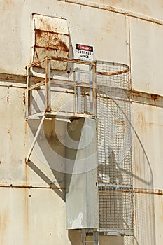 Red, black and white Danger, Confined Space warning sign on the exterior of a silo