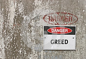 Red, black and white Danger, Greed warning sign photo