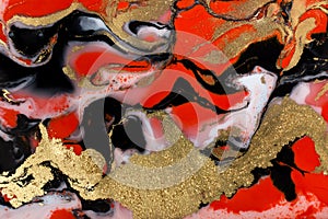 Red, black, white and gold paint liquid background. Abstract marble texture.