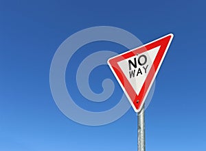 Red, black and white No Way road sign in a bright blue sky