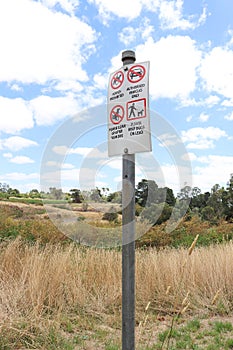 a red, black and white sign of instructions for visitors including Keep Dogs On Lead