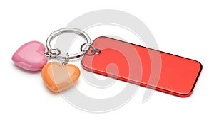 Red blank rectangular tag with heart charms on keychain