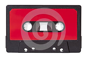 Red blank vintage cassette tape with an empty label isolated on white background, old retro audio equipment concept. Copy space