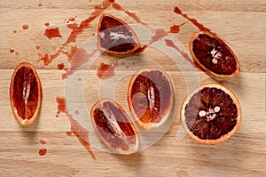 Red blood orange slices on wooden table and juice drops, healthy fruit diet Breakfast