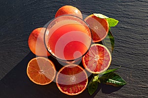 Red blood oranges juice on a slate plate