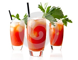 Red Bloody Mary drinks with ice cubes with celery isolated on white