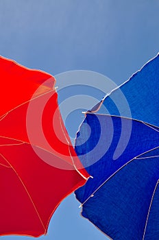 Red and blue beach umbrella and sky