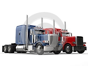 Red and blue big modern semi - trailer trucks - side by side
