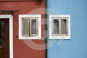 Red and blue building facade details in Burano Italy