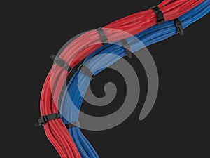 Red and blue cables bunched together and held together with zipties