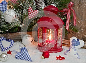 Red and blue Christmas decoration on window sill with hearts and photo
