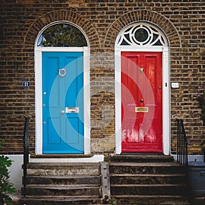 Red and Blue doors of a terrace Georgian house in London UK.