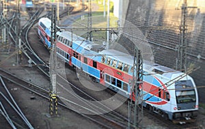 Red-blue double decker train arrives at the train station.