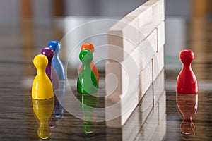 Red And Blue Figurine Paw Separated By Wooden Blocks