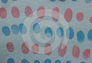 Red and blue finger prints on a color paper
