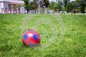 Red and blue fotball on grass photo