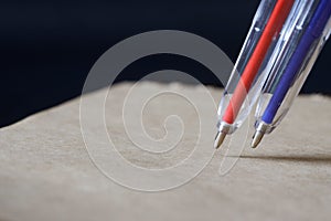 Red and blue fountain pens next to a sheet of eco-friendly recycled notebook. Concept for creativity, memory, learning, spelling