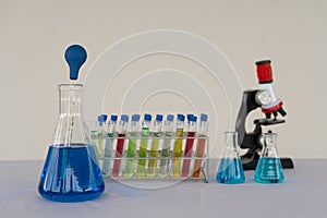 Red-blue glass bottles of various colors and chemical structure in research. medical science technology background Research and In