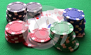 Red, blue, green, white and black poker chips and royal flush