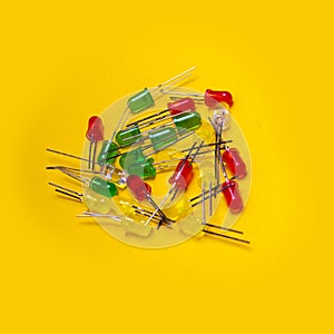 Red, blue, green or yellow transparent plastic electronic components over yellow