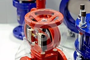 Red and blue industrial valves on white
