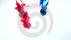 Red and blue ink in water.Creative slow motion. On a white background. Abstract background.