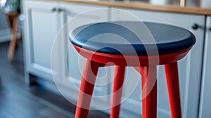 Red and blue kitchen stool in modern home setting.