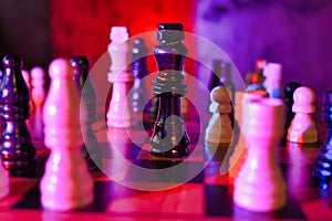 Red Blue Lit Chess Board with Focus on Black King Piece Static Shot